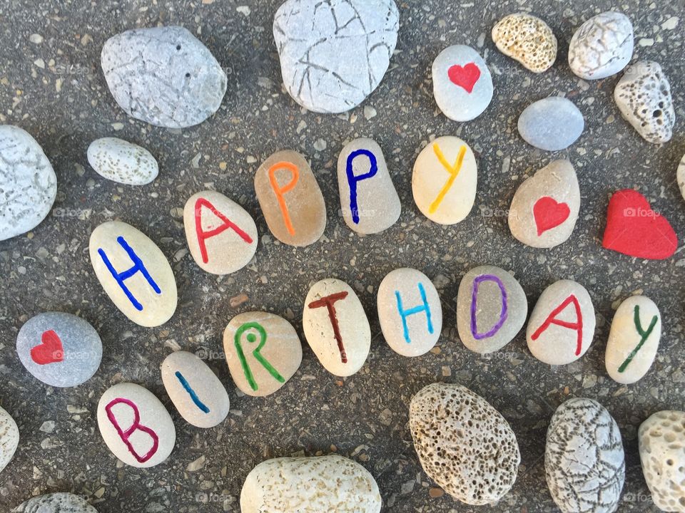 Happy Birthday composition. Happy Birthday message on carved and colored stones 