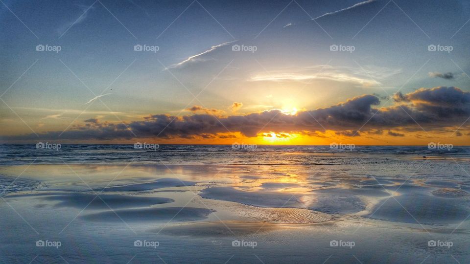 Dramatic sky reflected in sea