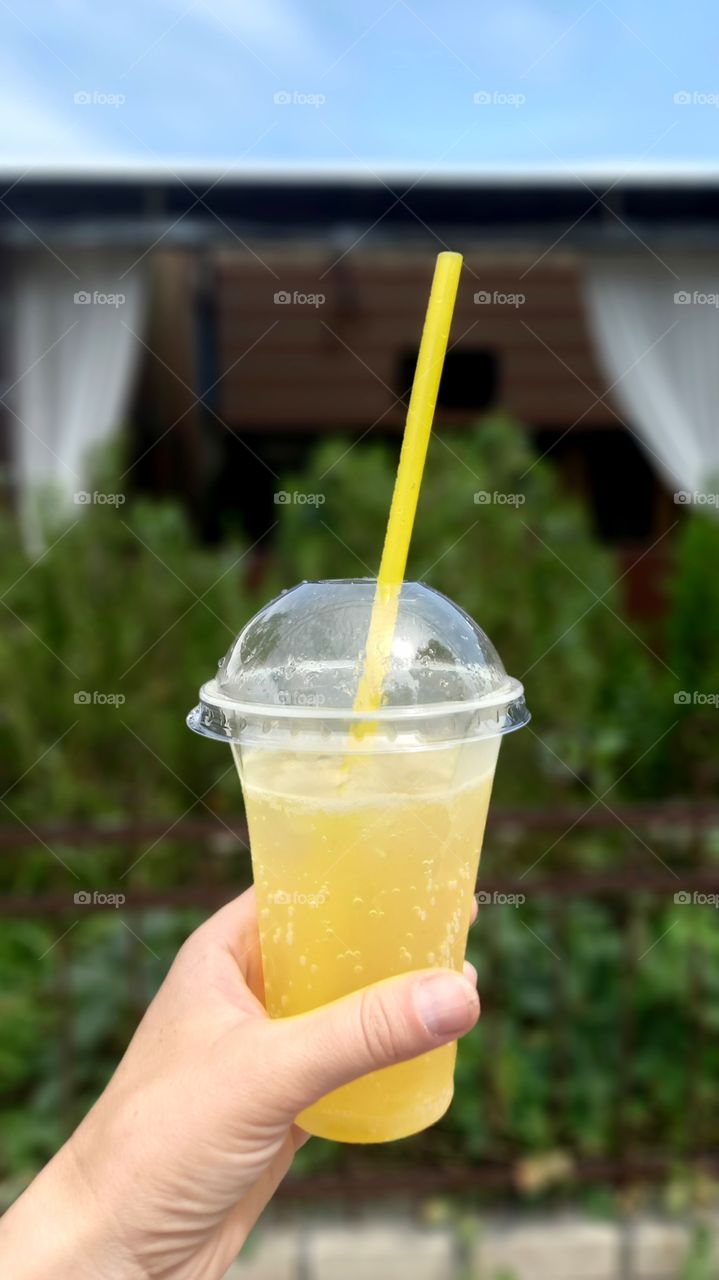 lemonade with a straw in the hand