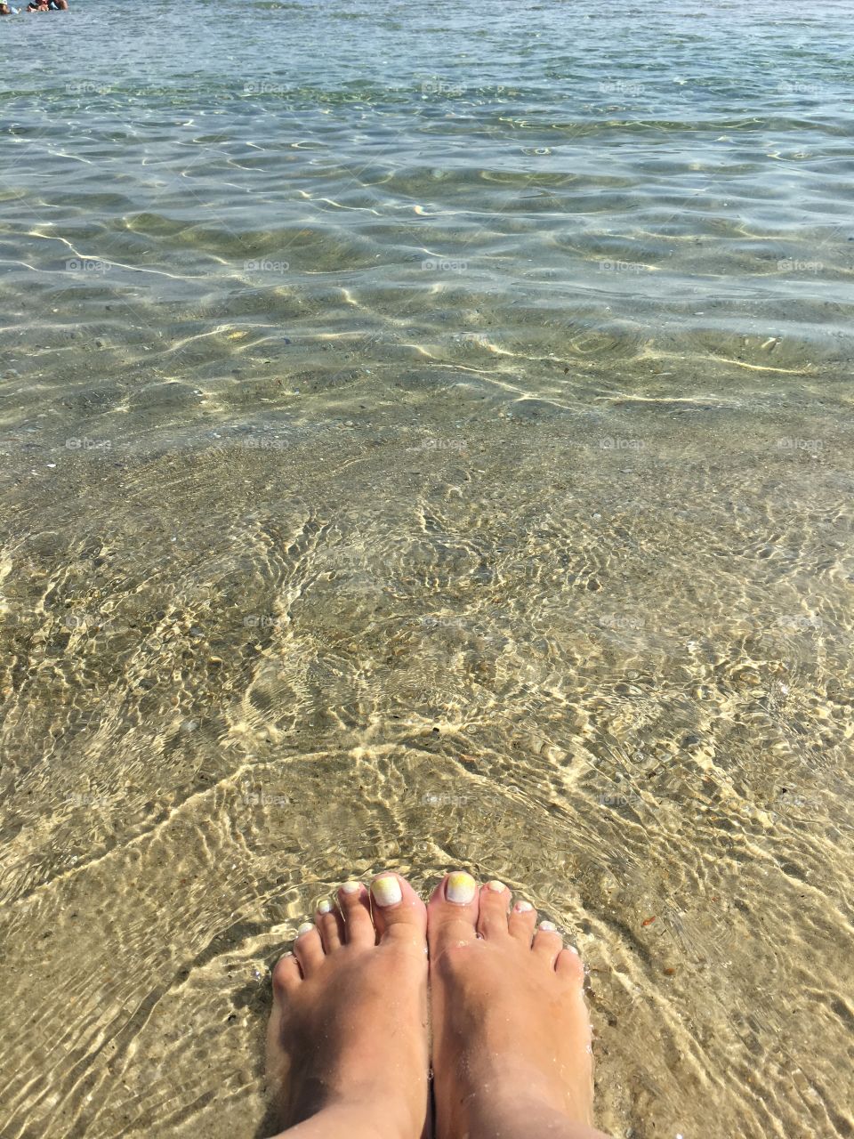 Feet in clear waters 