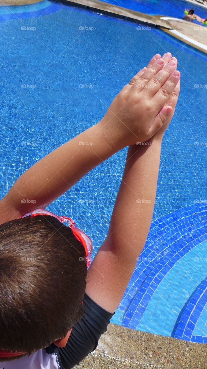 Young kid about to take a dive into pool