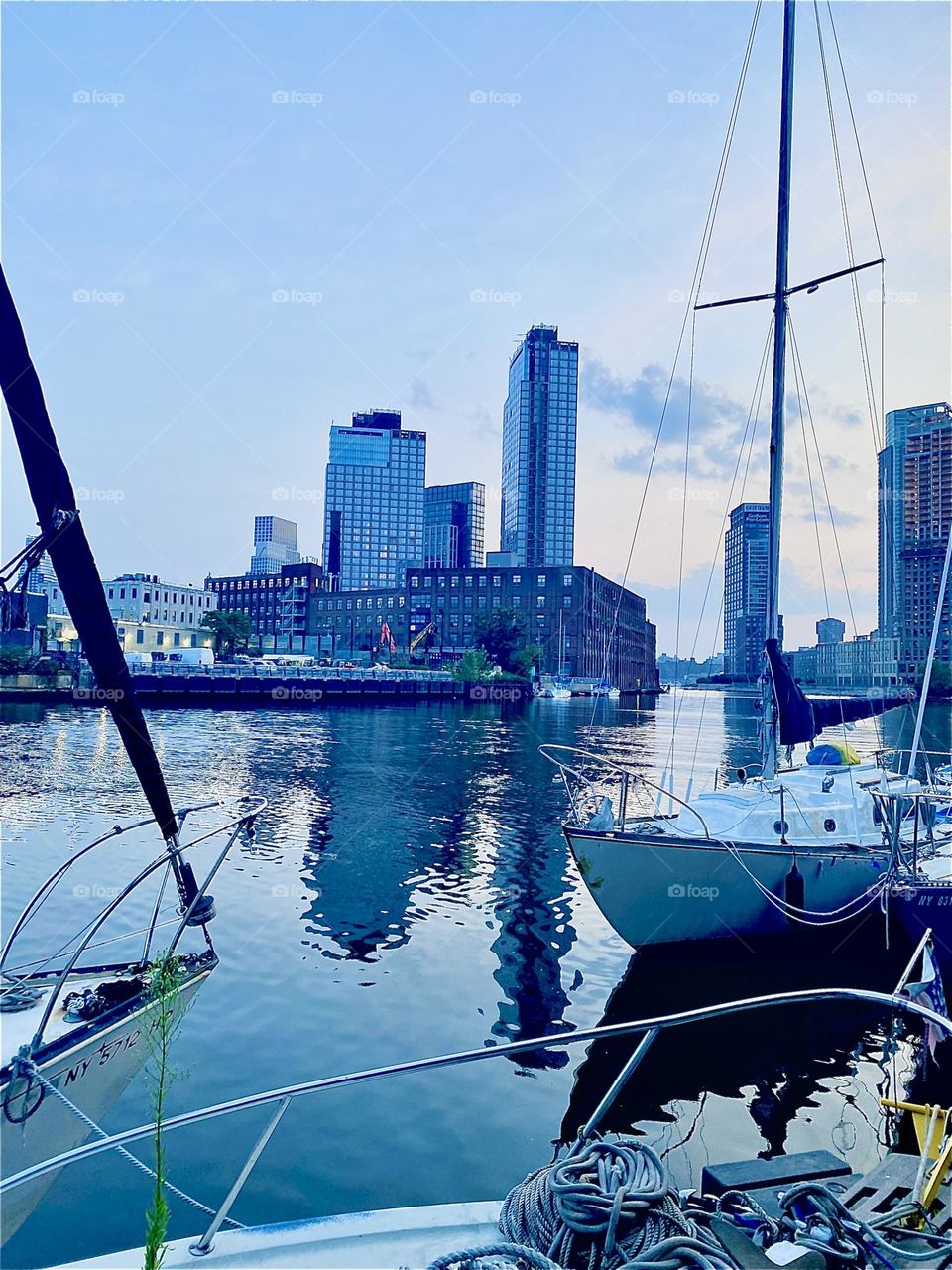 This is a beautiful view of “Newtown Creek” by the “Pulaski Bridge” in LIC, Queens at twilight time. Across the “East River” you can see “Greenpoint”, Brooklyn. 2023. Hypnotic Productions