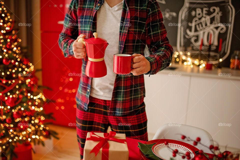 man sets a beautiful decorated winter table for a festive dinner.  Merry Christmas and Happy New Year.