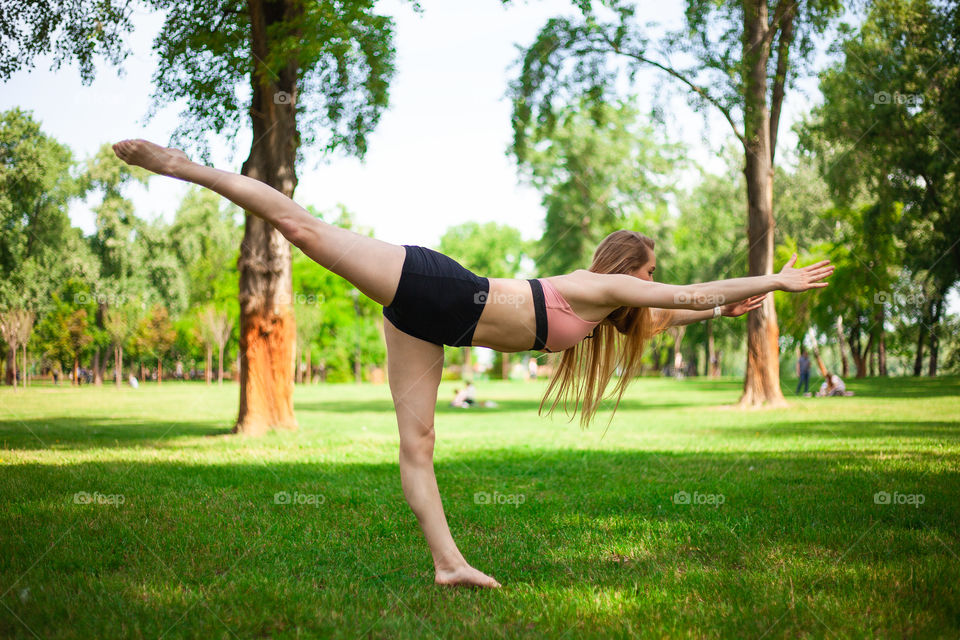 young woman doing yoga in the park