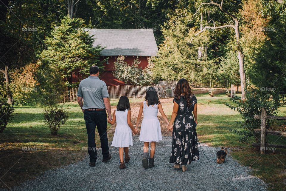 Family walking towards a barn 