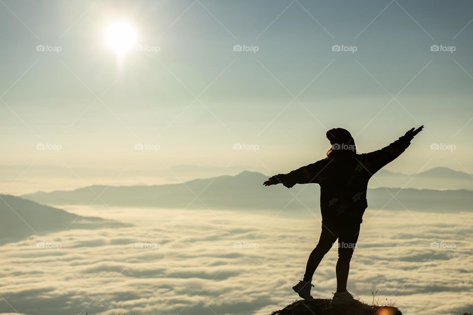 A tourist facing the ocean of mist on the peak of the Hill Chiangrai Thailand