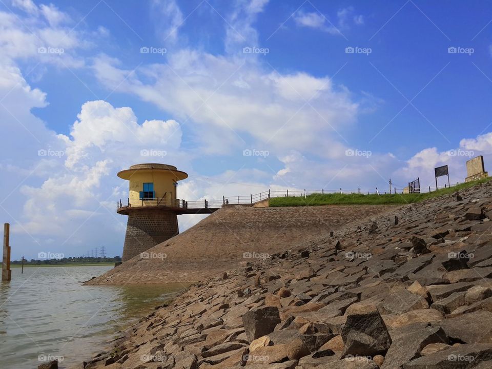 Lighthouse against cloudy sky