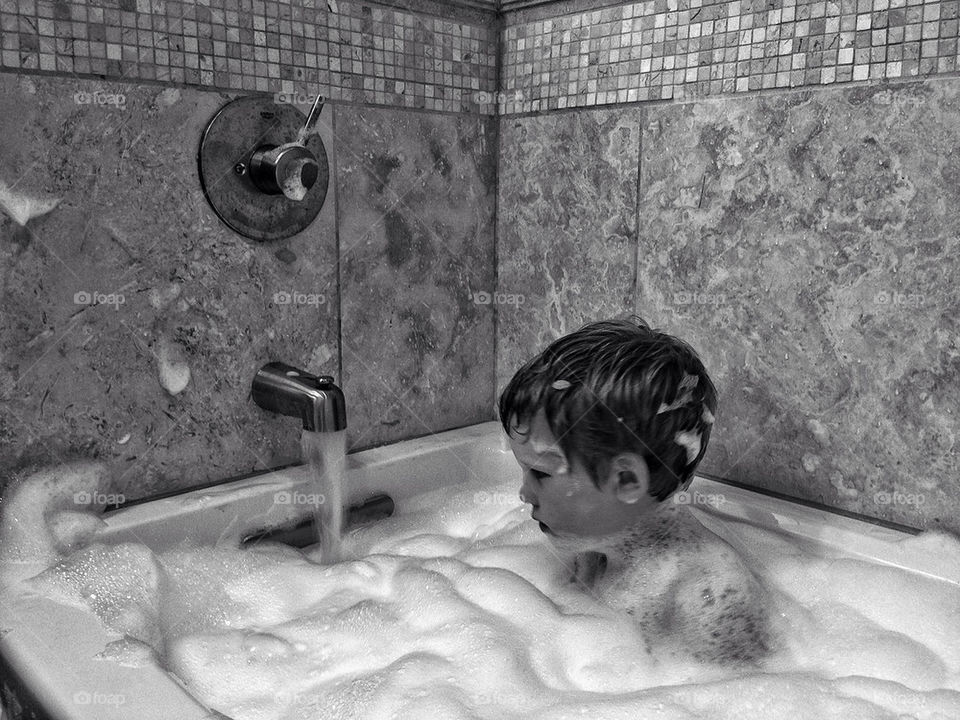 Boy taking a bubble bath