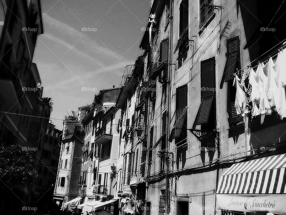 Street with laundry and shutters in Cinque Terre, Italy. Monochromatic. 