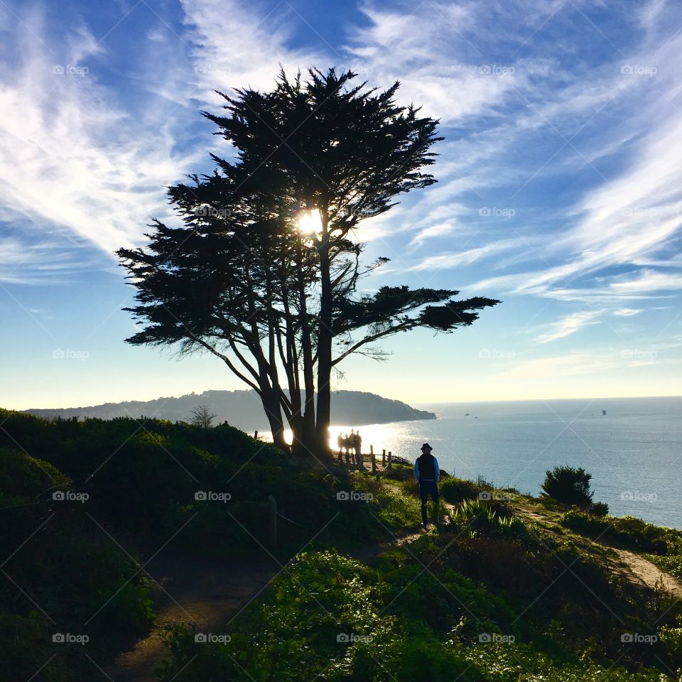 People on cliff near sea