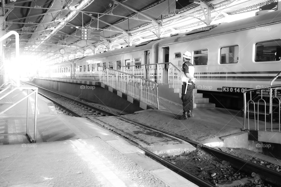 security guard facing the light in a train station