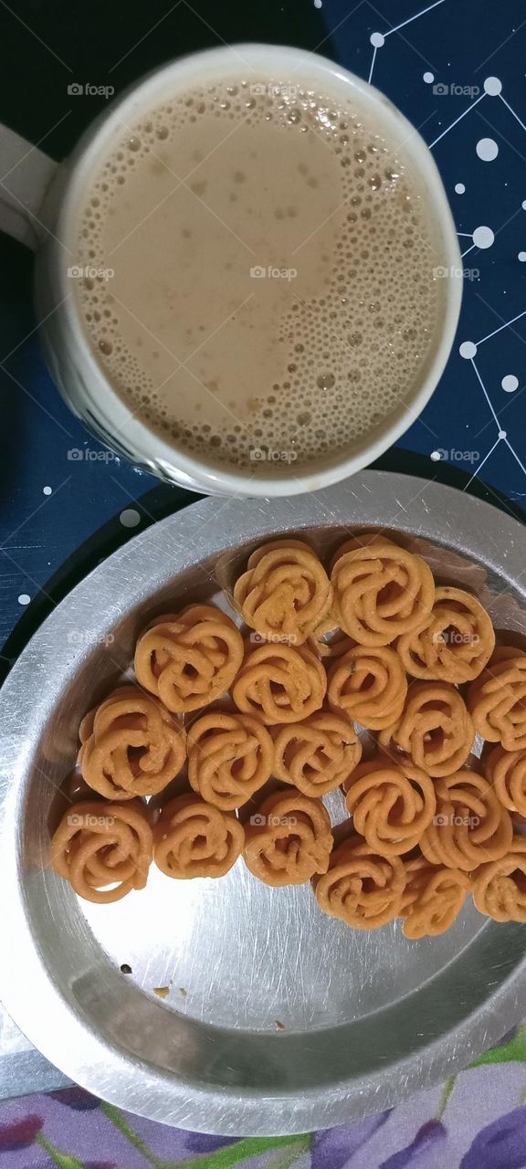 Tea is in circle shape cup. snacks is in circle shape plate and snacks also is in circle shape. We like sweet, hot tea with crunchy very tasty snacks.