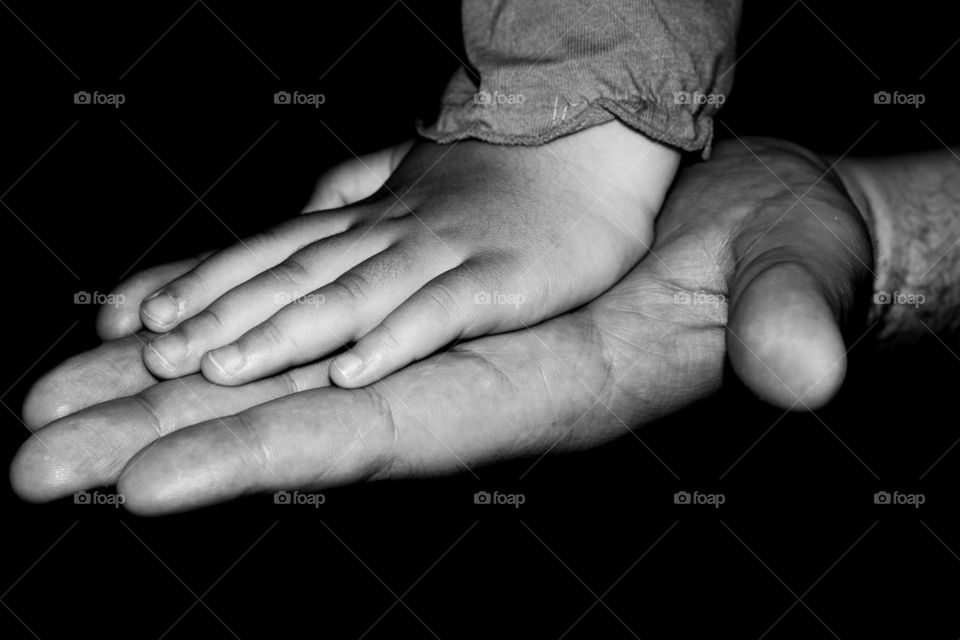 father holds daughter hand