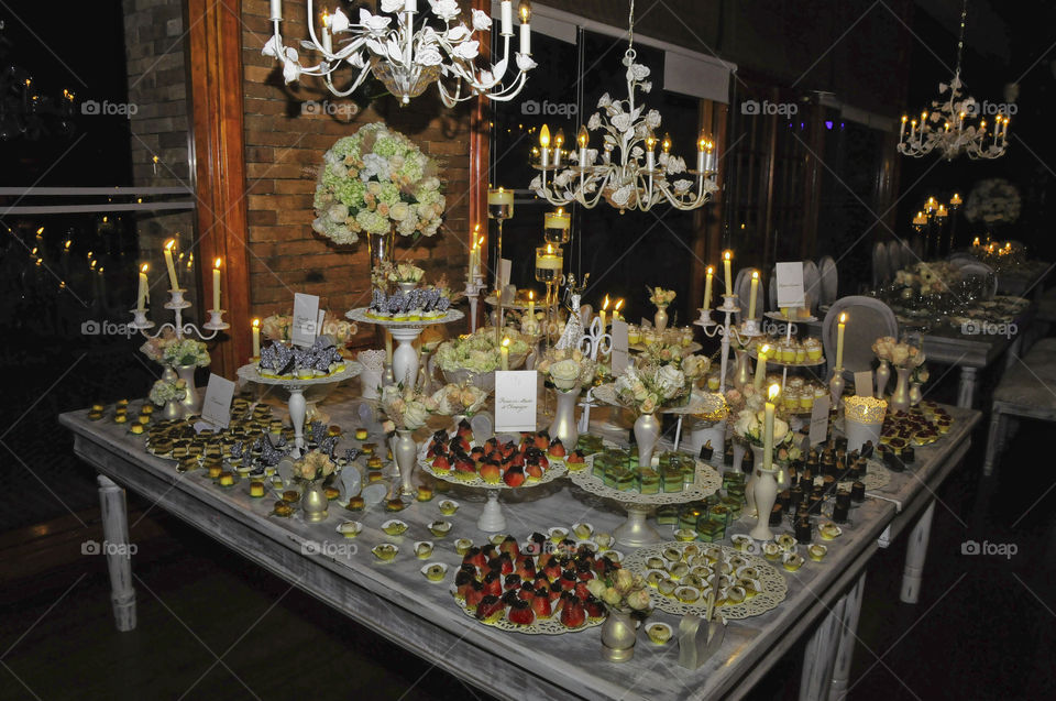 Dessert food at tables decorated with Flowers candles