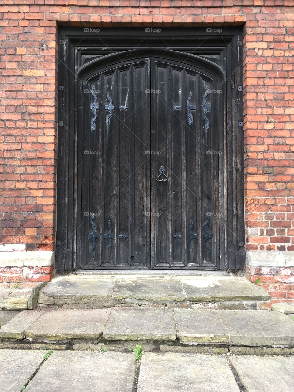 Really old vintage black doorway with steps at Gainsborough Old Hall in England 