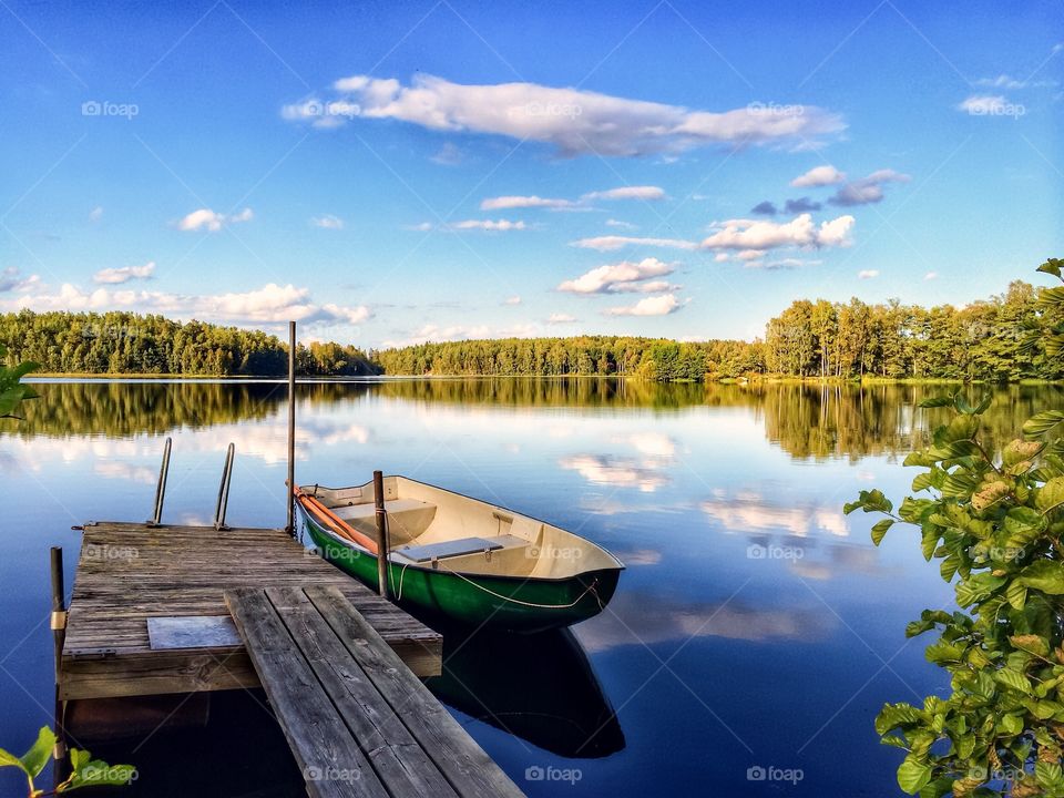 Boat at dock on lake