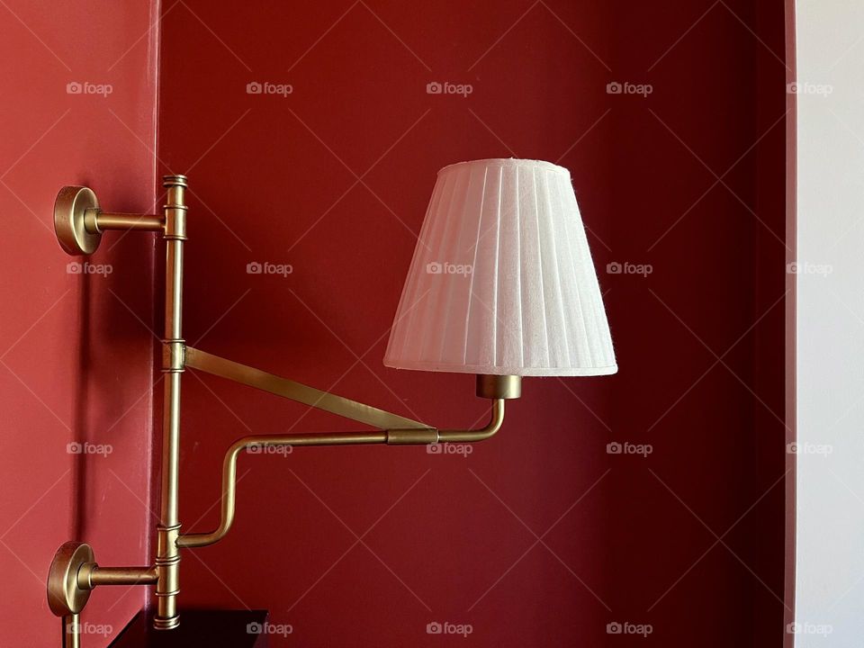 White lamp on the red wall background 