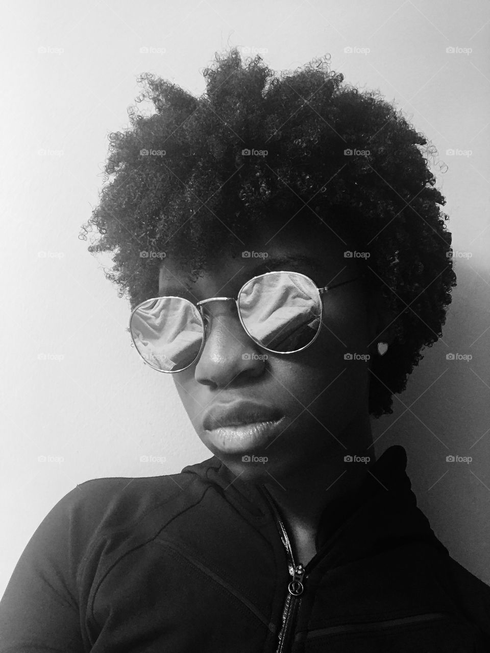 Girl with Natural hair, shades, and an even shadier glare