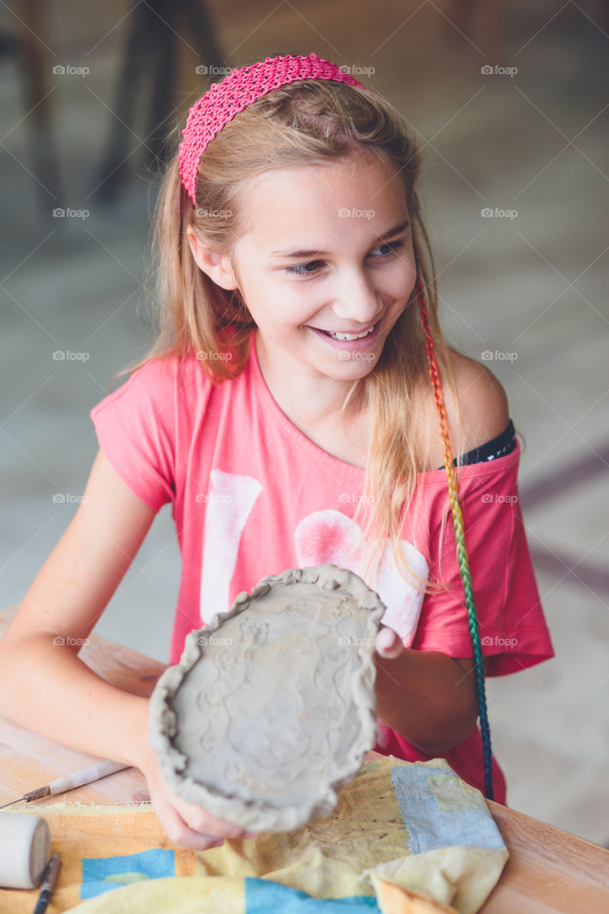 Cute girl creating with clay