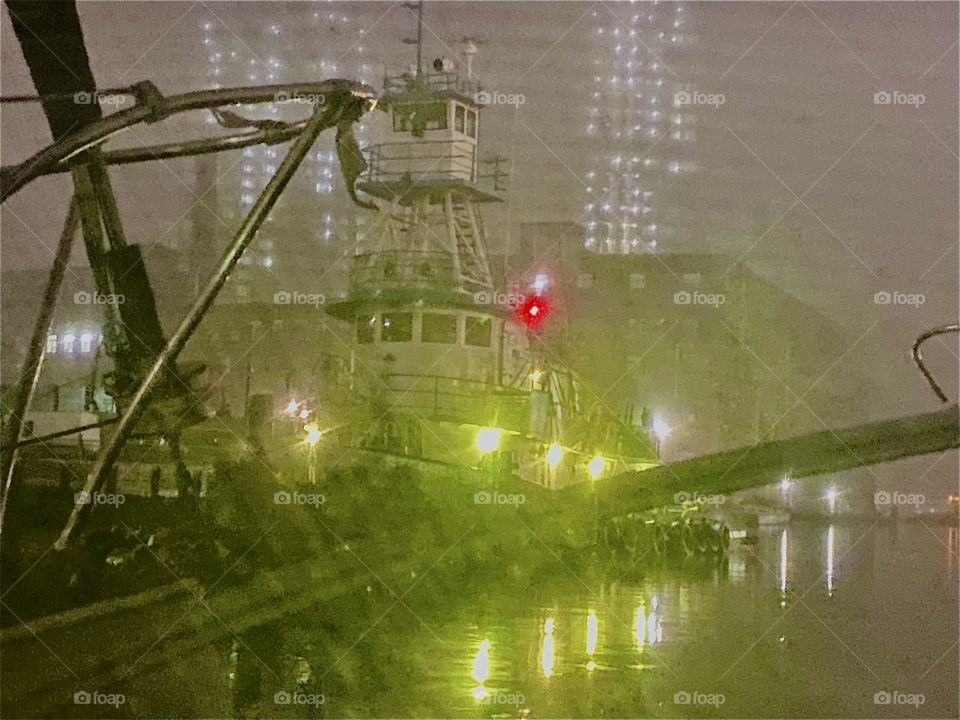 The views from our boat at “Newtown Creek” in “Long Island City”, Queens are spectacular such as this atmospheric motif of a large ship with illumination making its way past us in the fog. 2023. Hypnotic Productions