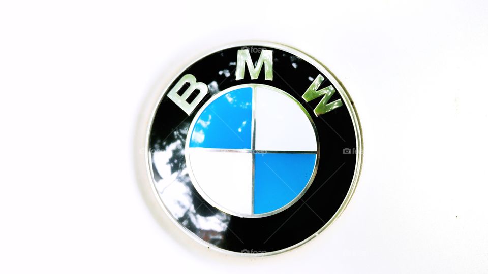 A car sign BMW with its reflective surface