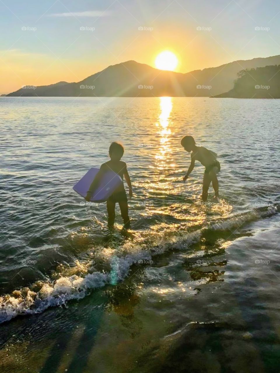 Two kids playing on the beach