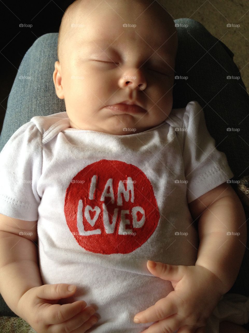 A first born grandchild wearing Helzberg Diamonds logo 