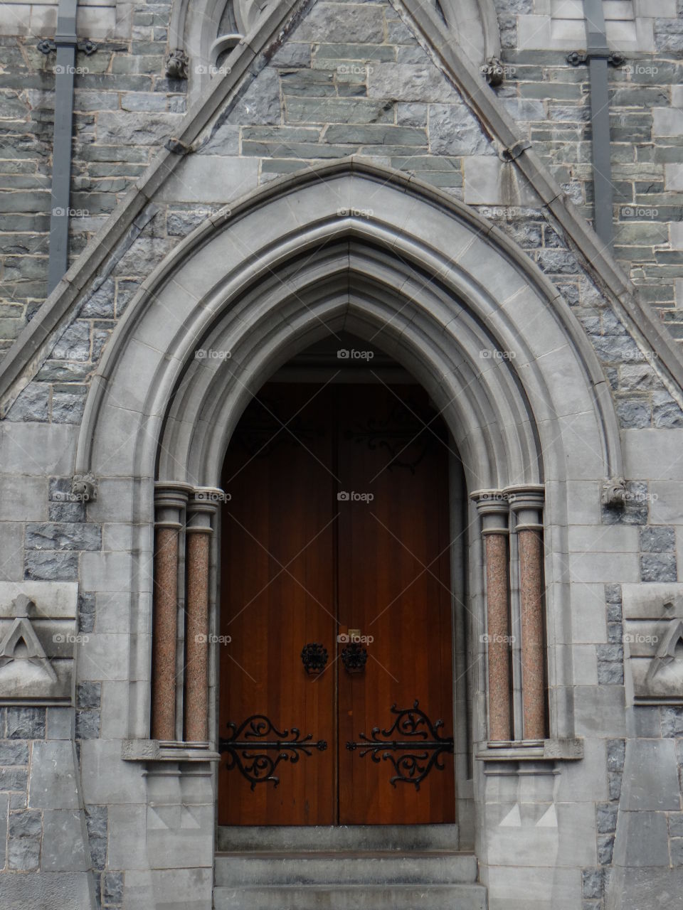 Wooden door in stone archway 