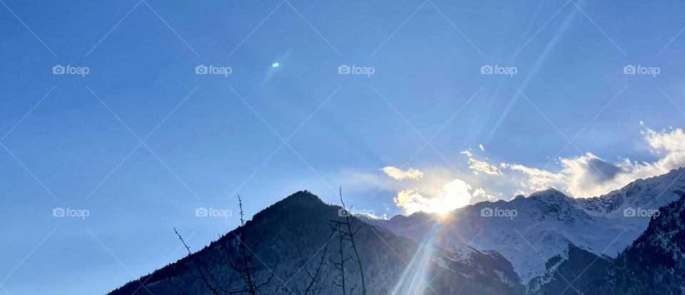 Panorama of sunset view on mountain peaks 