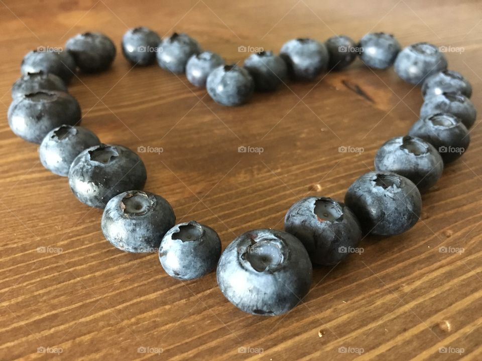 Blueberries heart on table