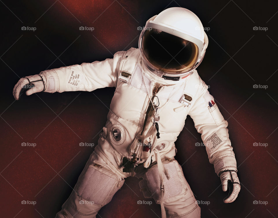 Astronaut with reddish dust behind