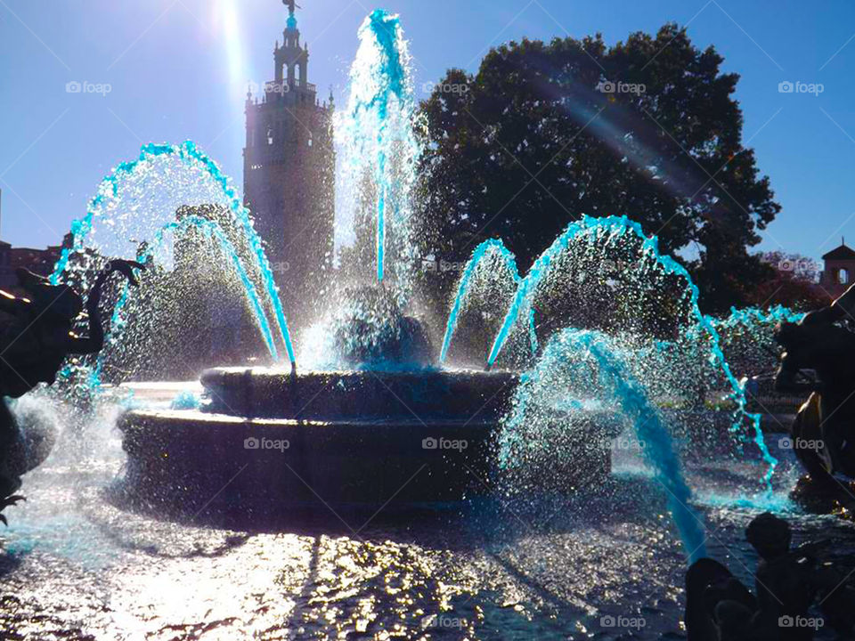 JC Nichols Fountain, Country Club Plaza, Kansas City. The fountain is cast in bright sunlight. The water was blue in honor of our Kansas City Totals.