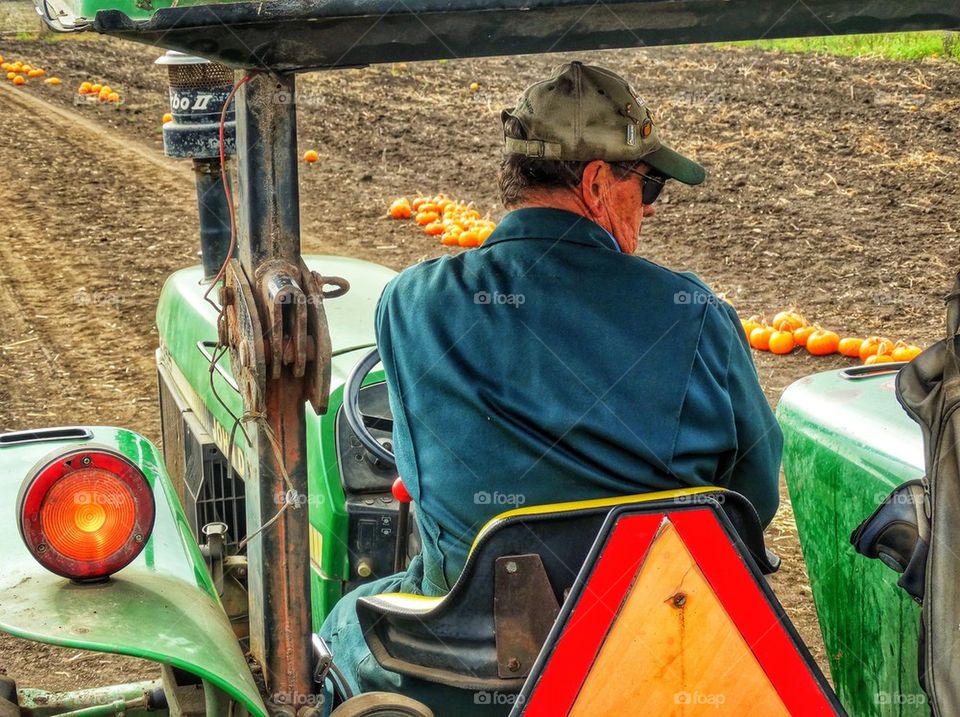 Farmer Driving A Tractor