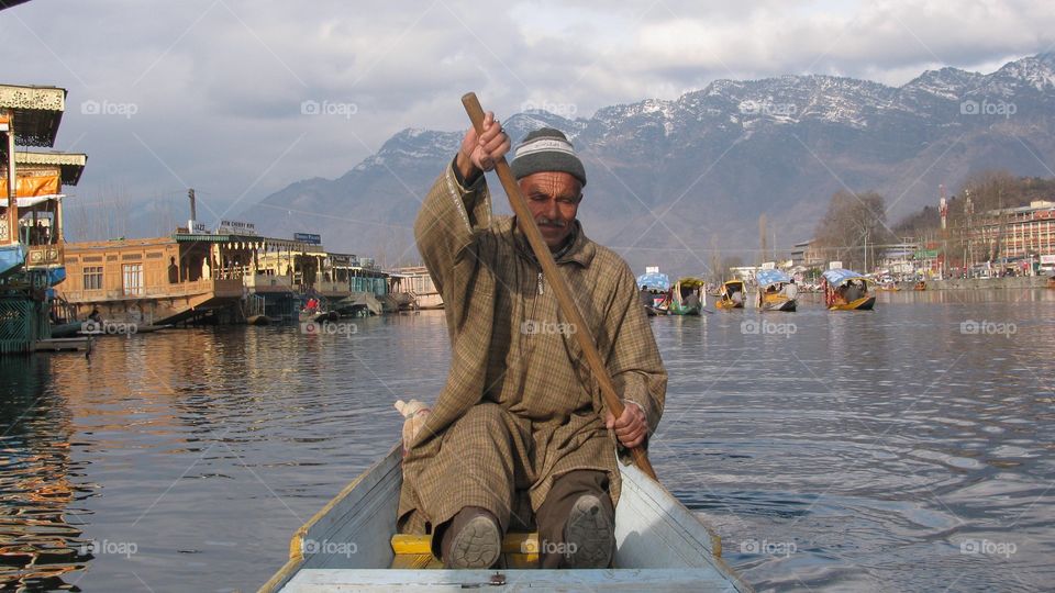 Senior man boating in river