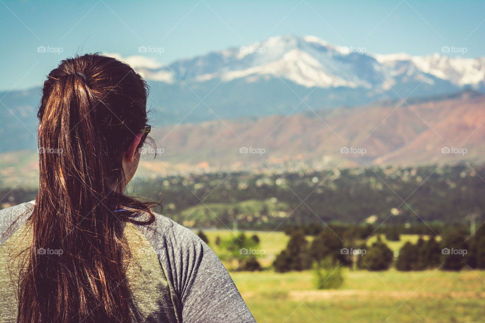 Girl Looking Out at Pikes Peak Mountain Range 