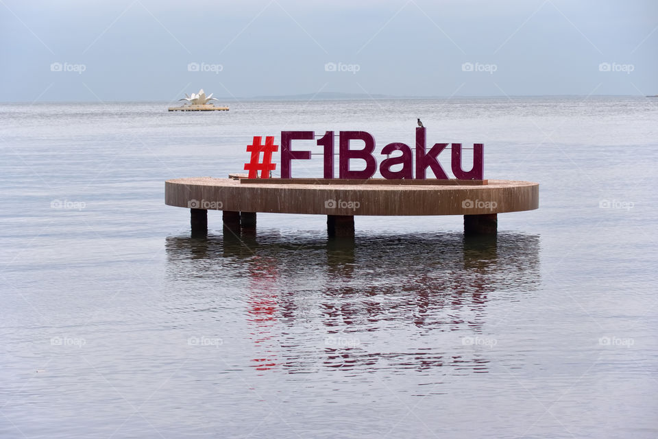 Baku, Azerbaijan - December 22, 2017: Formula 1 sign over water on cloudy December early evening at Bay of Baku in Baku, Azerbaijan. 