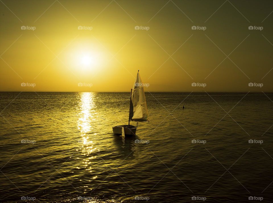 A boat on the beach at a sunset 