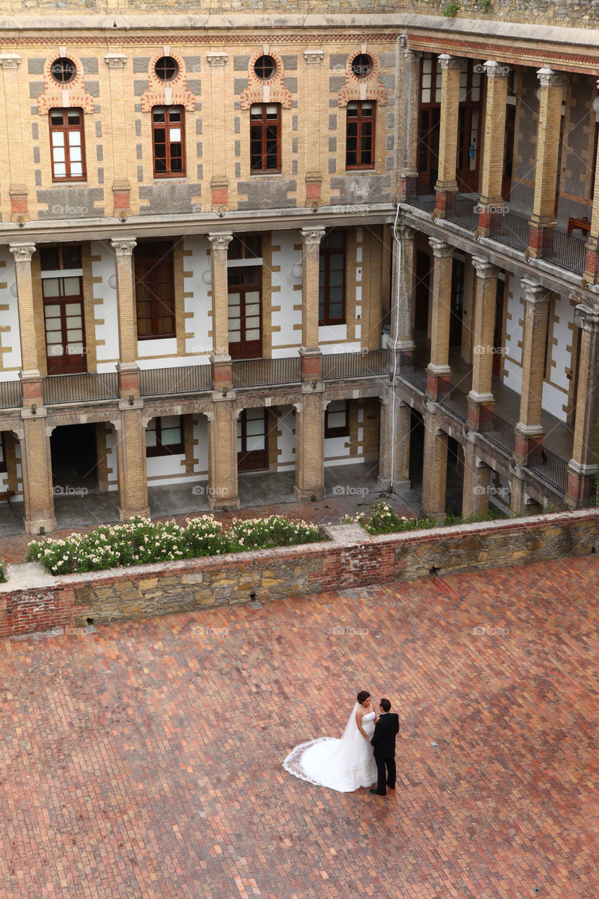 Young couple of new weds contemplate each other on a vintage classic