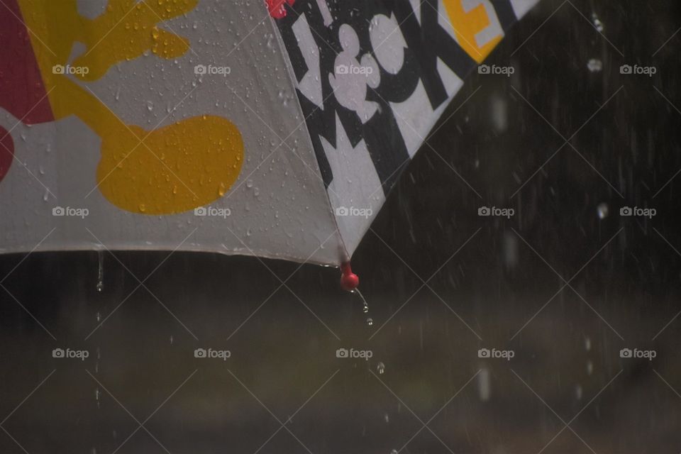rain drops falling on colorful umbrella