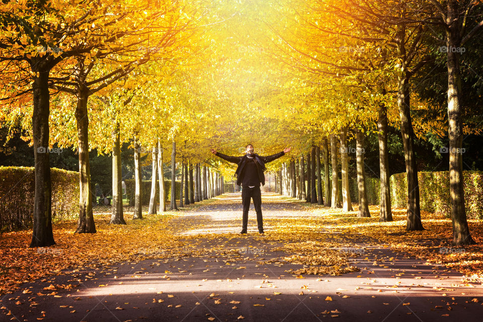 Man standing in autumn trees