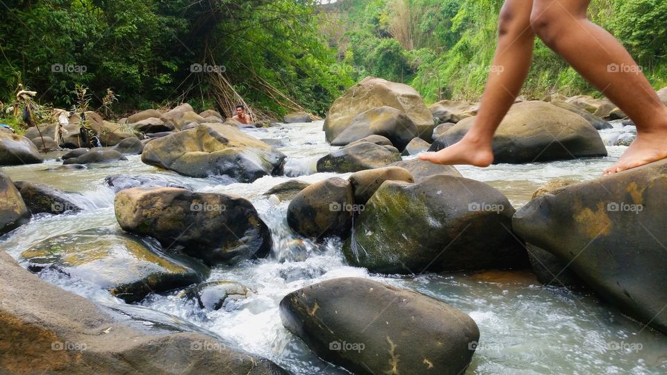 walk on a pile of stones in a river