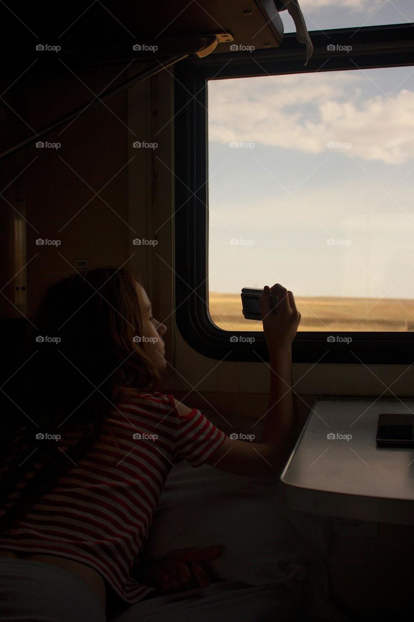 Girl near the window in the train