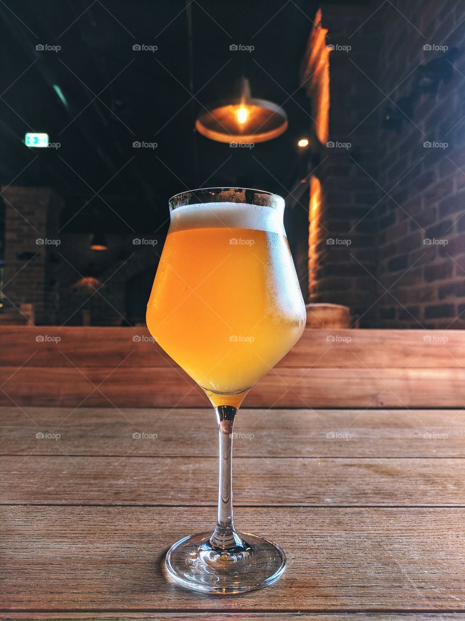 The glass of cold craft beer in hot summer day.