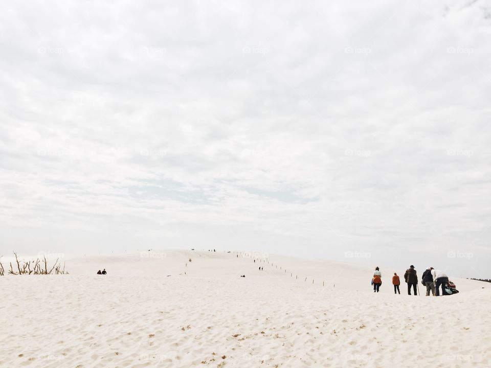 Group of people standing in sand