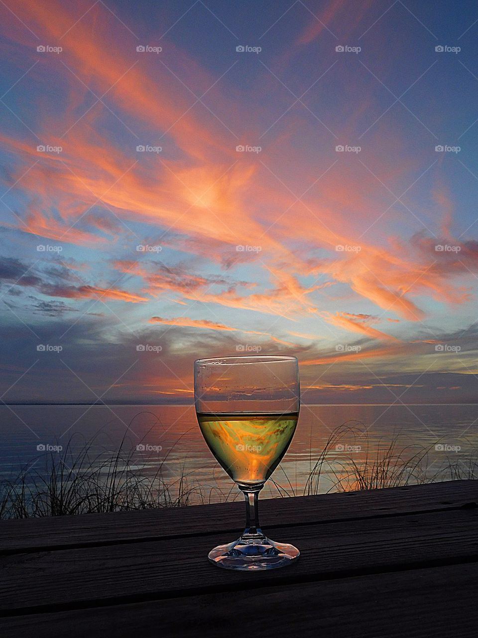 “Wine Not” A glass of refreshing wine absorbs the magnificent sunset reflection off the colorful clouds