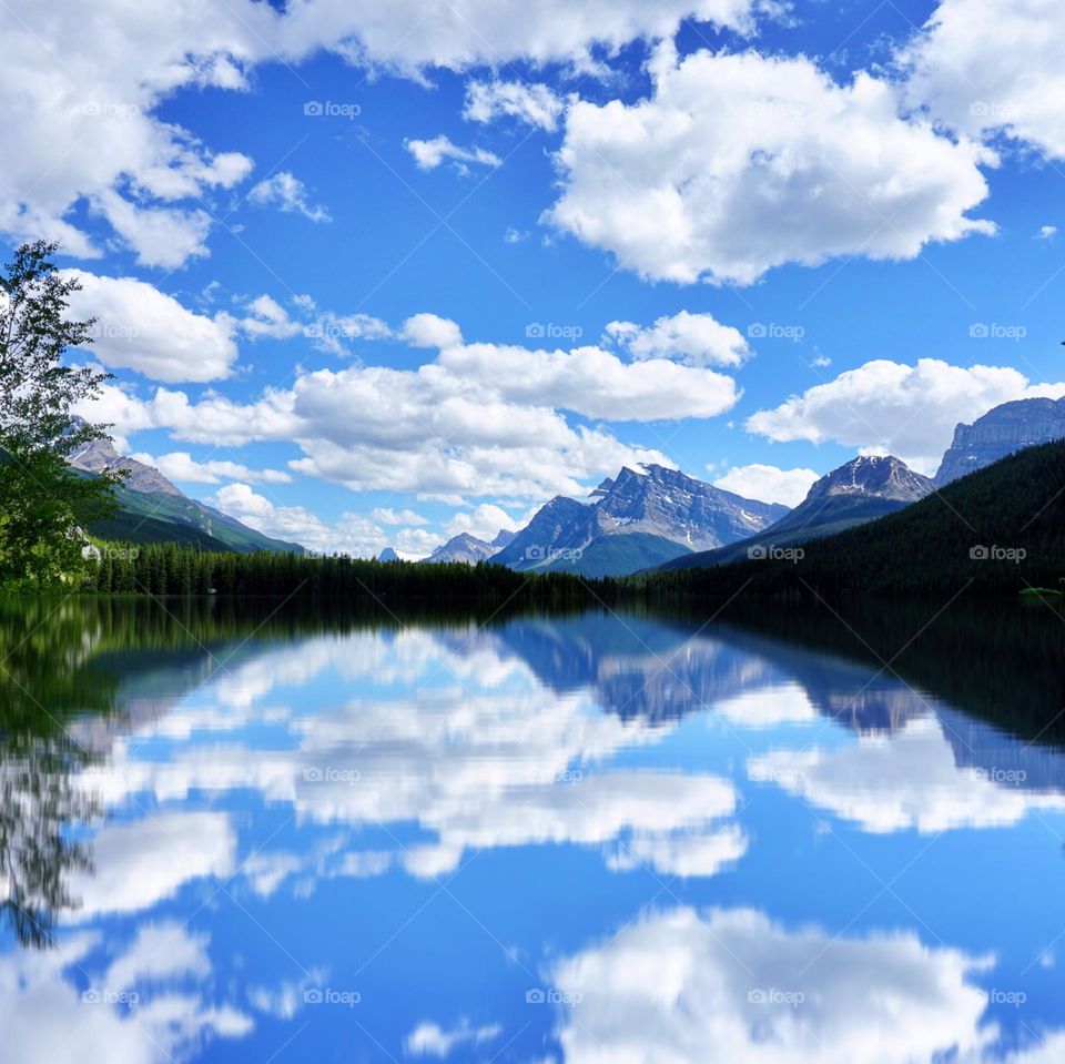 Puffy clouds hovering above a Lake 