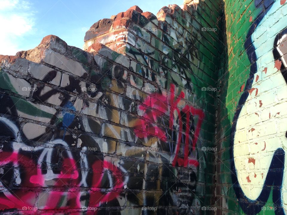 A brick wall with graffiti 