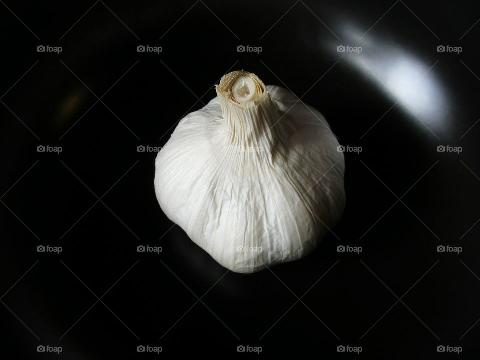 Garlic bulb on the black background