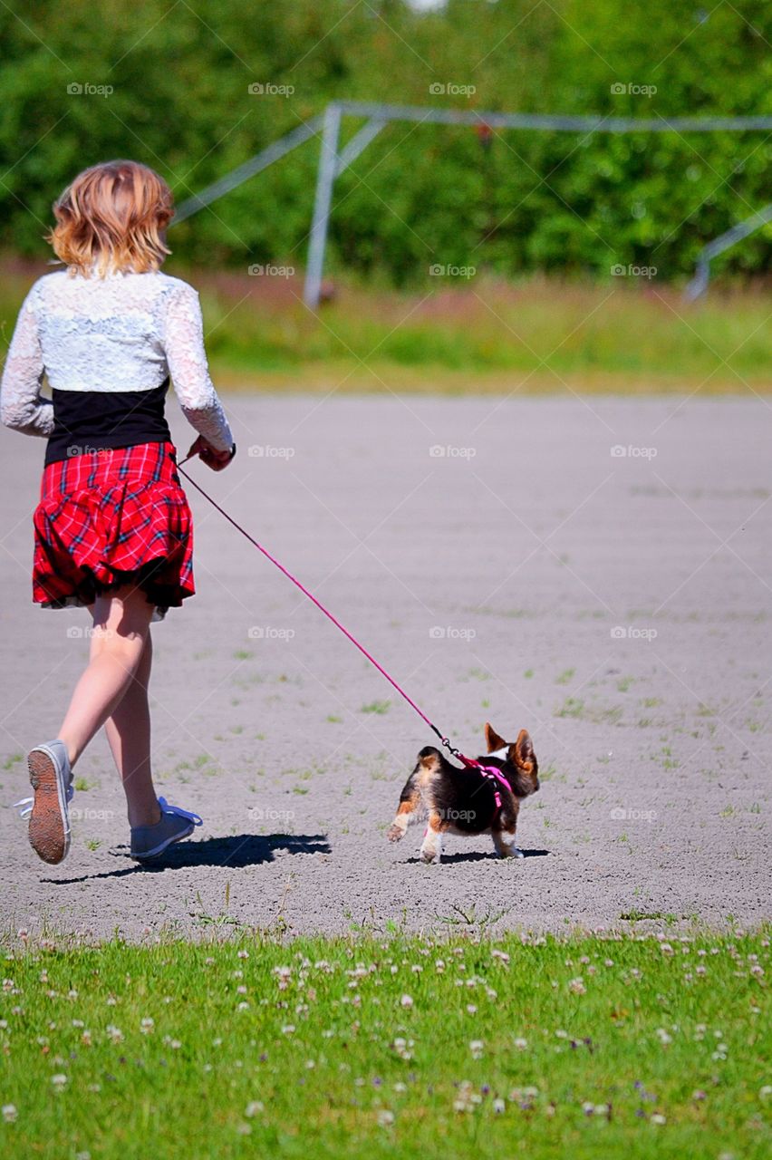 Running. Girl running with her puppy