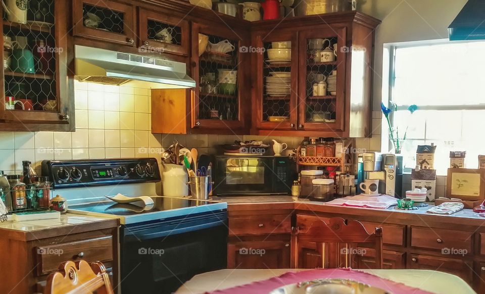 At home in my country kitchen with chicken wire on the cabinets cooking for my family